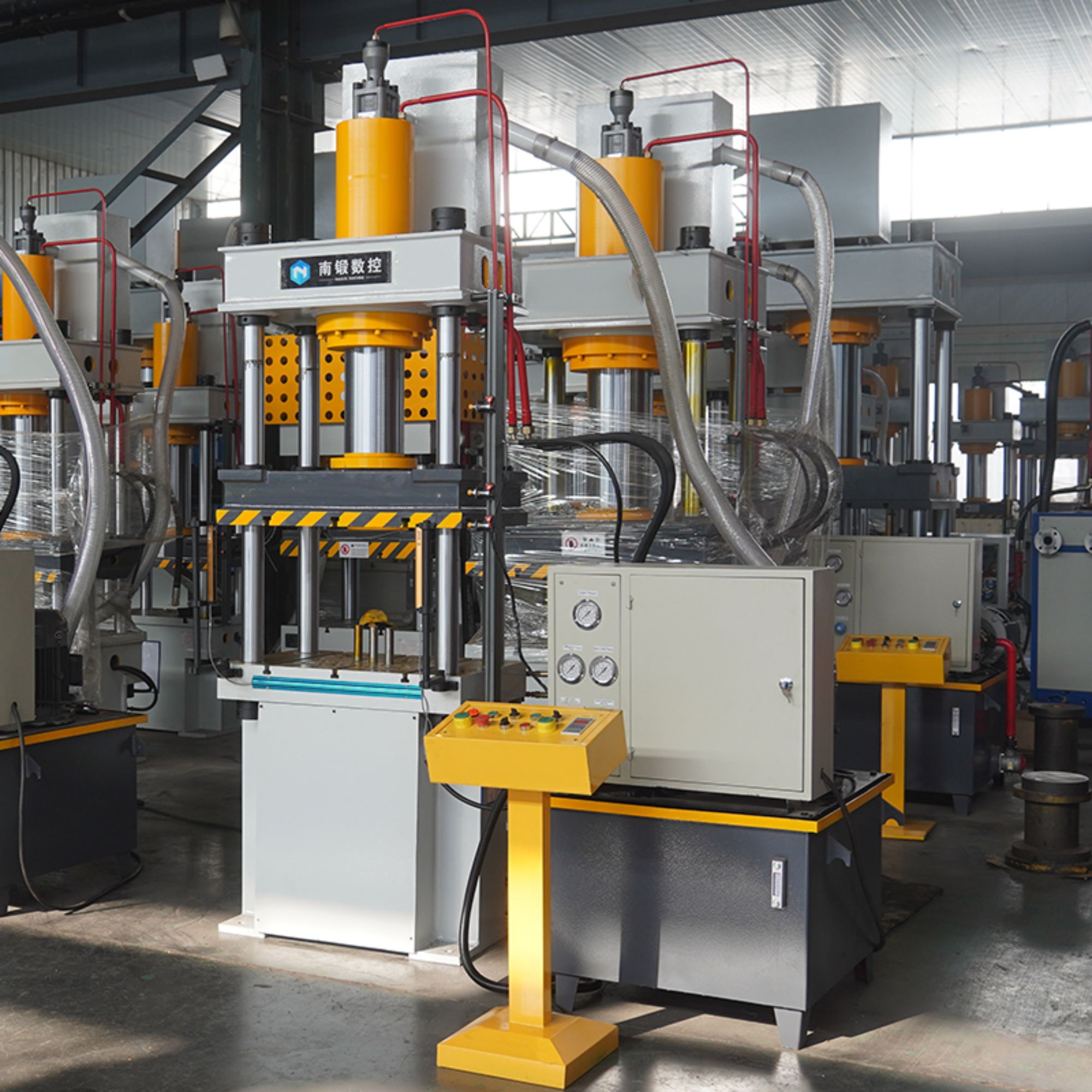 What types of materials can be processed using the 100-ton deep drawing machine with hydraulic cushion and multi-rod ejection safety light curtain?
