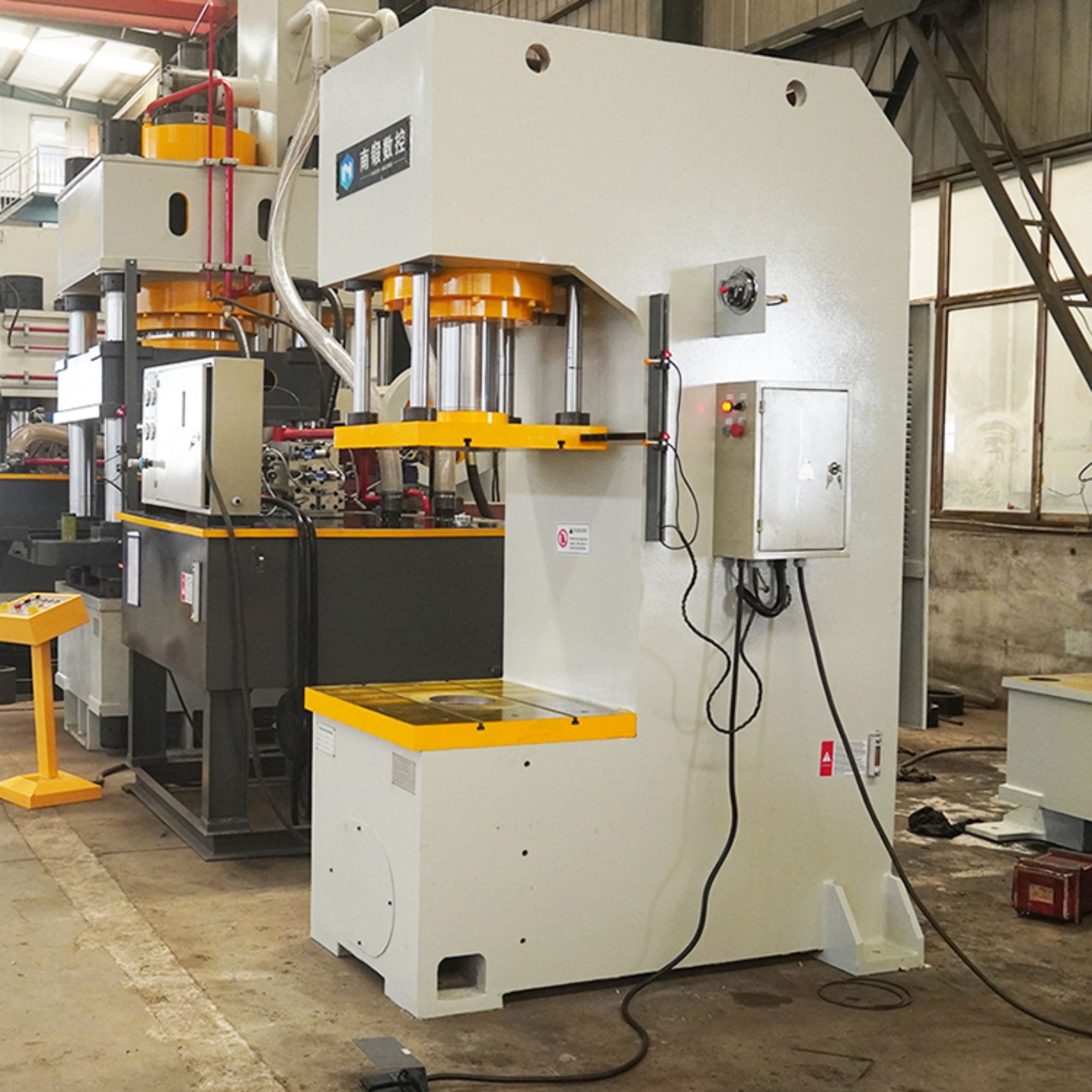 How do you ensure the safety of operators when using a 200-ton C-frame hydraulic press?