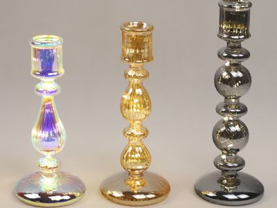 How can you incorporate tall glass candlesticks into seasonal decor?