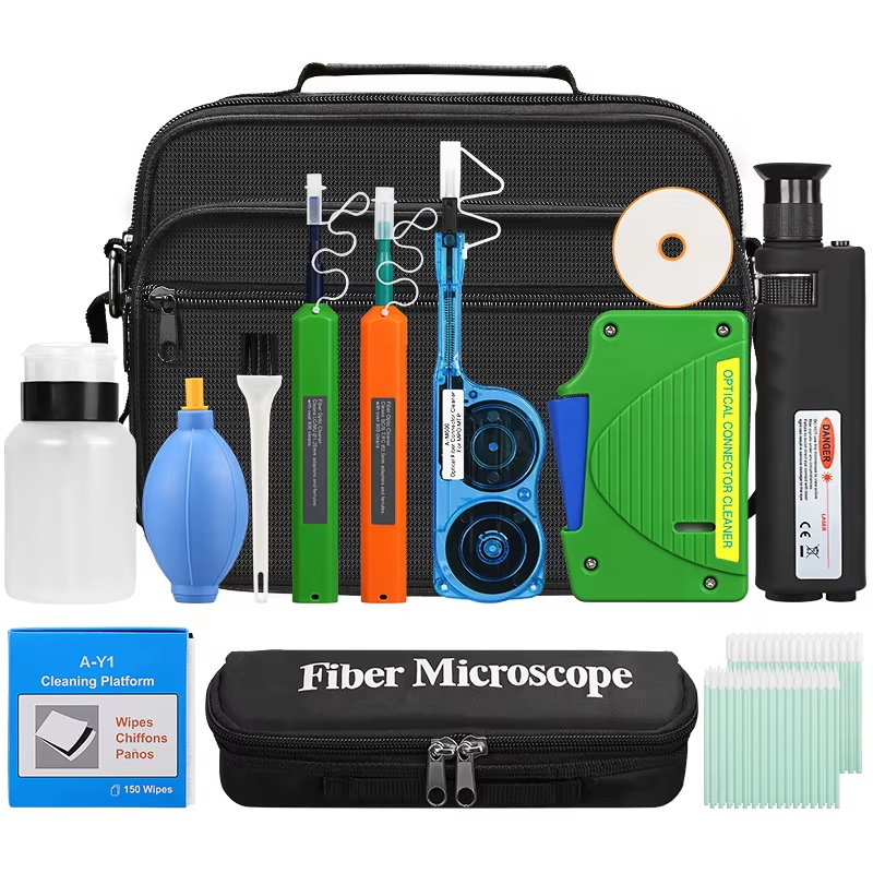 What are the essential tools in a Fiber Optic Cleaning Kit?